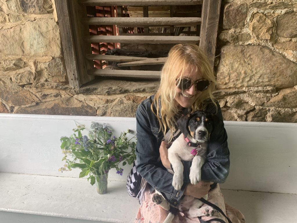 Picture of Andrea Sachs with her foster dog, Olive, on their trip to Virginia to get a bouquet of flowers.