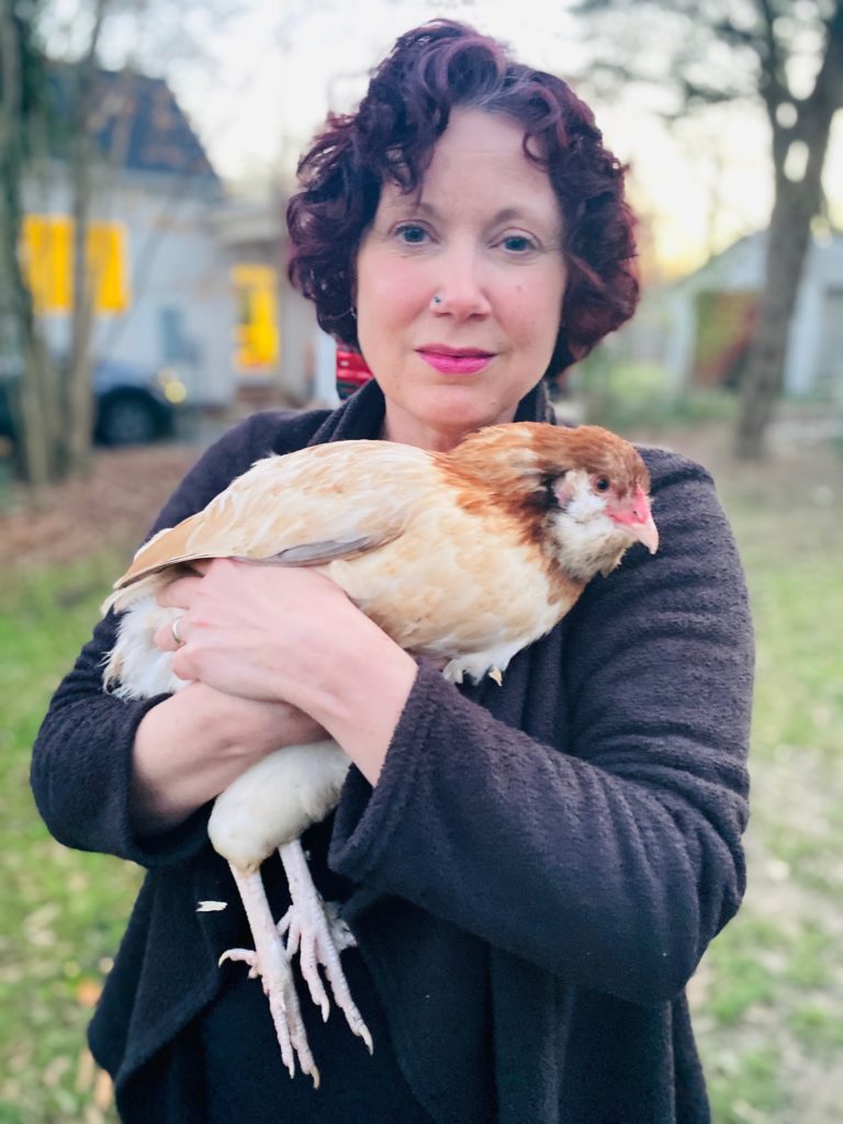 Picture of Heather Primm, holding one of her hens.